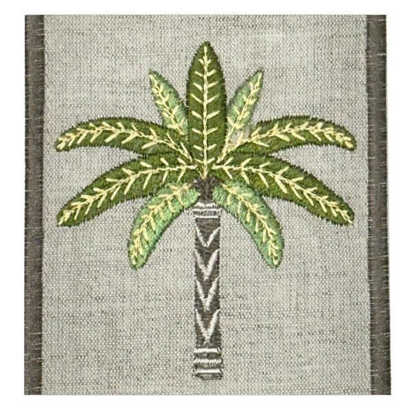 Embroidered palm tree patch on gray fabric background with a bordered edge